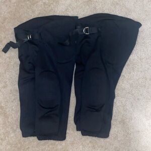 Two pairs of youth size medium black padded Champro football pants.